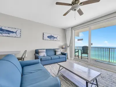 a living room with a couch and a table at Shores of Panama 1002 in Panama City Beach