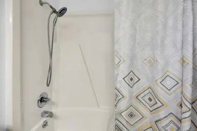 a bathroom with a shower with a shower curtain at Top of the Gulf 421 - Luxury Beach View Condo in Panama City Beach