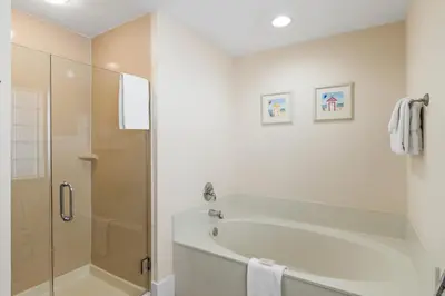 a white bathroom with a tub and a shower at Boardwalk Beach Resort #1400 by Book That Condo in Panama City Beach