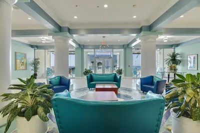 a lobby with blue chairs and a table at Boardwalk Beach Resort #1400 by Book That Condo in Panama City Beach