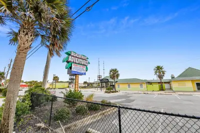 a sign for a motel on a street with palm trees at Boardwalk Beach Resort #1400 by Book That Condo in Panama City Beach