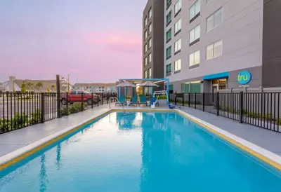 a swimming pool in front of a building at Tru By Hilton Panama City Beach in Panama City Beach