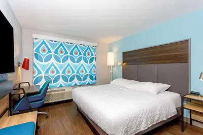 a hotel room with a bed and a desk and a tv at Tru By Hilton Panama City Beach in Panama City Beach
