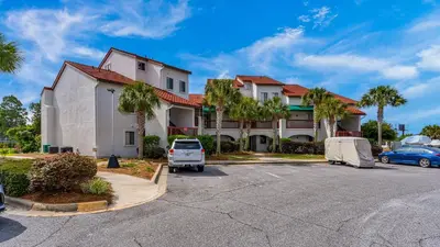 a building with a car parked in a parking lot at St Thomas Square 1208A in Panama City Beach
