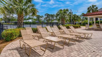 a row of chairs sitting on a brick patio at St Thomas Square 1208A in Panama City Beach
