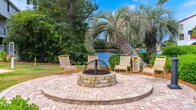 a group of chairs sitting around a fire pit at St Thomas Square 1208A in Panama City Beach