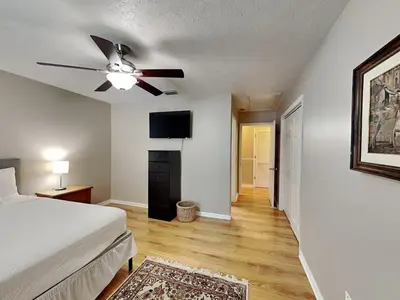a bedroom with a bed and a ceiling fan at Gulf Six in Panama City Beach