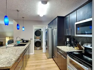 a large kitchen with a washer and dryer at Gulf Six in Panama City Beach
