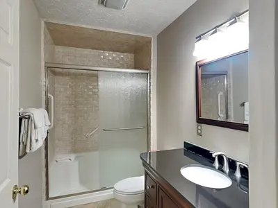 a bathroom with a shower and a sink and a toilet at Gulf Six in Panama City Beach