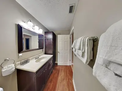 a bathroom with a sink and a mirror at Gulf Six in Panama City Beach