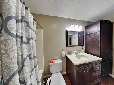 a bathroom with a sink and a toilet and a mirror at Gulf Six in Panama City Beach