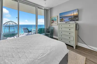 a bedroom with a bed and a large window at Aqua Resort 903 in Panama City Beach