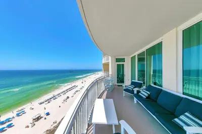 a view of the beach from the balcony of a building at Aqua Resort 903 in Panama City Beach
