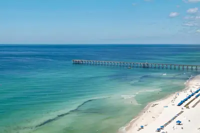 an aerial view of a beach with a pier at Aqua Resort 903 in Panama City Beach