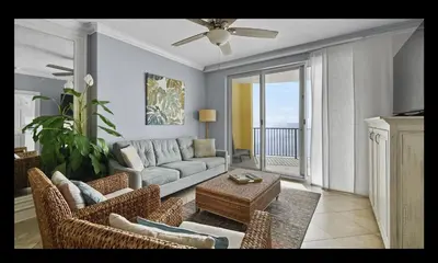 a living room with a couch and a table at Beautiful Beachfront Views - The Retreat at Emerald Isle in Panama City Beach