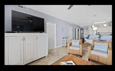 a living room with a large flat screen tv at Beautiful Beachfront Views - The Retreat at Emerald Isle in Panama City Beach