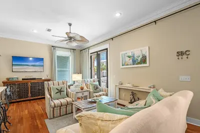 a living room with a couch and chairs and a tv at Sugar Beach Cottage in Inlet Beach