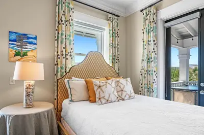 a bedroom with a bed and a window at Sugar Beach Cottage in Inlet Beach
