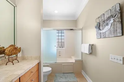 a bathroom with a toilet and a sink at Sugar Beach Cottage in Inlet Beach