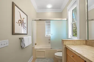 a bathroom with a toilet and a window at Sugar Beach Cottage in Inlet Beach