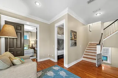 a living room with a staircase leading to a bedroom at Sugar Beach Cottage in Inlet Beach