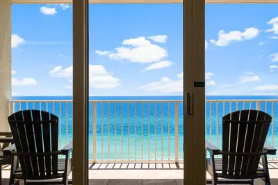 a balcony with two chairs and a view of the ocean at Beachfront Bliss Luxe 3BR Condo at Marisol Complex in Panama City Beach