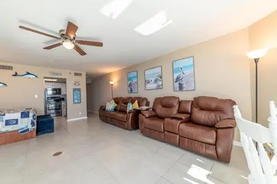 a living room with two couches and a ceiling fan at Sunbird 1204W 'Humphries Hideaway' in Panama City Beach