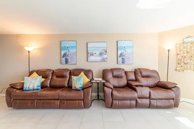 two brown leather couches in a living room at Sunbird 1204W 'Humphries Hideaway' in Panama City Beach