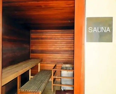 a sauna with a wooden bench and a stool at Twin Palms 1903 'No Bad Days' in Panama City Beach
