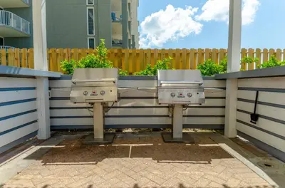 two toilets sitting on a fence with plants at Twin Palms 1903 'No Bad Days' in Panama City Beach