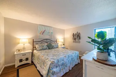 a bedroom with a bed and a potted plant at Edgewater 3-1113 'Ocean's 1113' in Panama City Beach