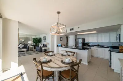 a kitchen and dining room with a table and chairs at Edgewater 3-1113 'Ocean's 1113' in Panama City Beach