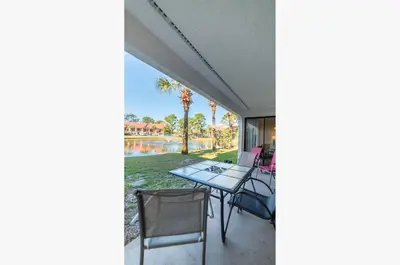 a view from the porch of a house with a table and chairs at Edgewater Villa 3001 'Vitamin Sea' in Panama City Beach