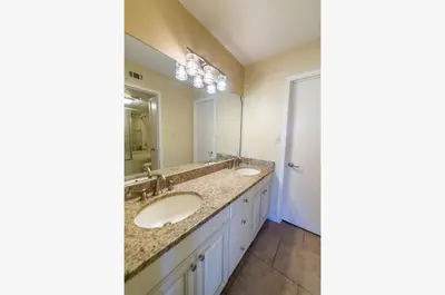 a bathroom with two sinks and a large mirror at Edgewater Villa 3001 'Vitamin Sea' in Panama City Beach