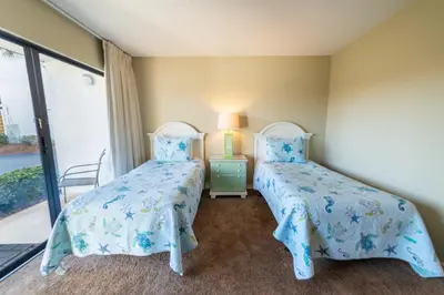 two beds in a room with a window at Edgewater Villa 3001 'Vitamin Sea' in Panama City Beach