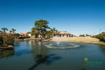 a fountain in the middle of a pond at Edgewater Villa 3001 'Vitamin Sea' in Panama City Beach