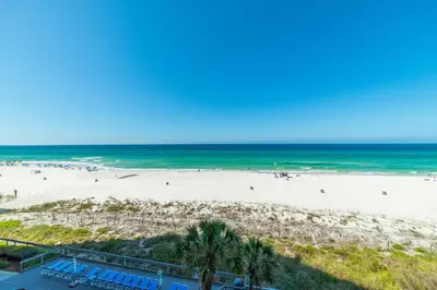 an aerial view of a beach with palm trees and the ocean at Edgewater 3-0404 'Isle Be Back' in Panama City Beach
