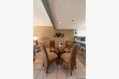 a kitchen and dining room with a table and chairs at Edgewater 3-0404 'Isle Be Back' in Panama City Beach