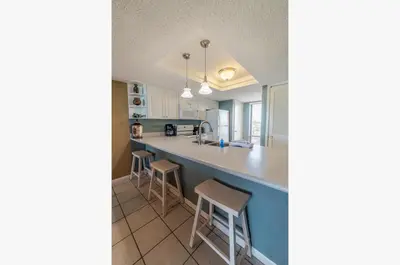 a kitchen with a large counter top and stools at Edgewater 3-0404 'Isle Be Back' in Panama City Beach