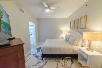 a bedroom with a bed and a ceiling fan at Shores of Panama 1520 'Thirsty Turtle' in Panama City Beach