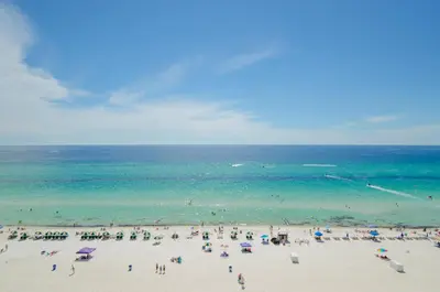 a group of people on a beach with the ocean at Shores of Panama 1520 'Thirsty Turtle' in Panama City Beach