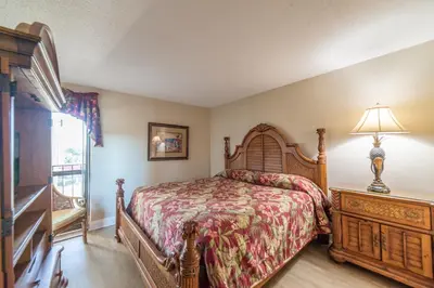 a bedroom with a bed and a window at Edgewater 1-0502 'Island Paradise' in Panama City Beach