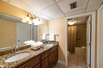a bathroom with two sinks and a large mirror at Edgewater 1-0502 'Island Paradise' in Panama City Beach