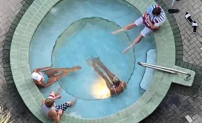 a group of people swimming in a swimming pool at Edgewater 1-0502 'Island Paradise' in Panama City Beach
