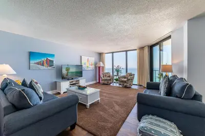 a living room with two couches and a tv at Edgewater 2-1202 'Shore Fun Penthouse' in Panama City Beach