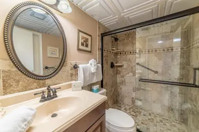 a bathroom with a sink and a shower at Edgewater L301 'The Nauti Starfish' in Panama City Beach