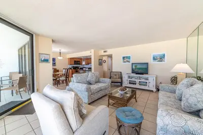 a living room with couches and a tv at Edgewater L301 'The Nauti Starfish' in Panama City Beach