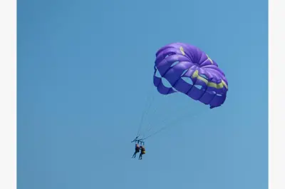 a paratrooper flying in the sky with a parachute at Sunbird 0405E 'No Worries' in Panama City Beach