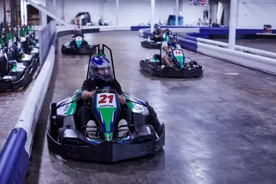 a child riding in a race car on a track at Sunbird 0405E 'No Worries' in Panama City Beach