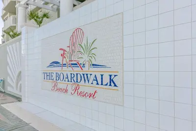 a sign for the beachwalk urgent resort on a tile wall at Boardwalk 0605 'Good Times & Tan Lines' in Panama City Beach